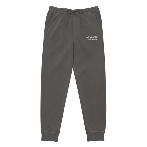 Dark gray sweatpants with a logo on the left leg against a white background